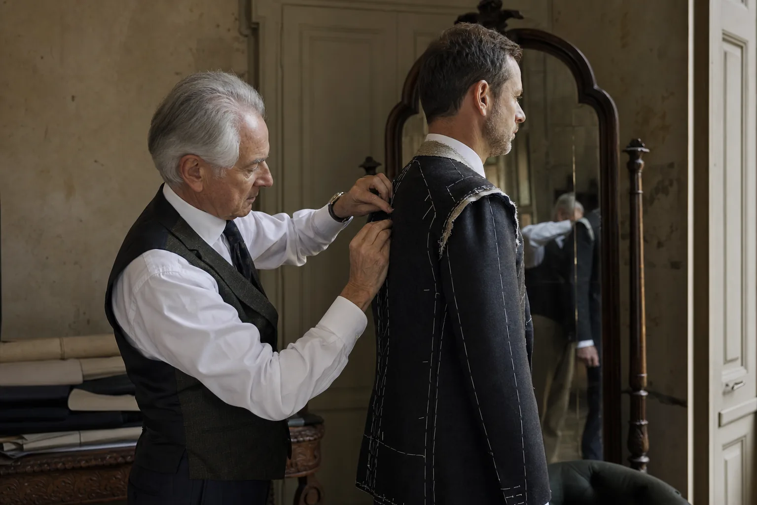 A tailor reviewing the balance of a fitting garment